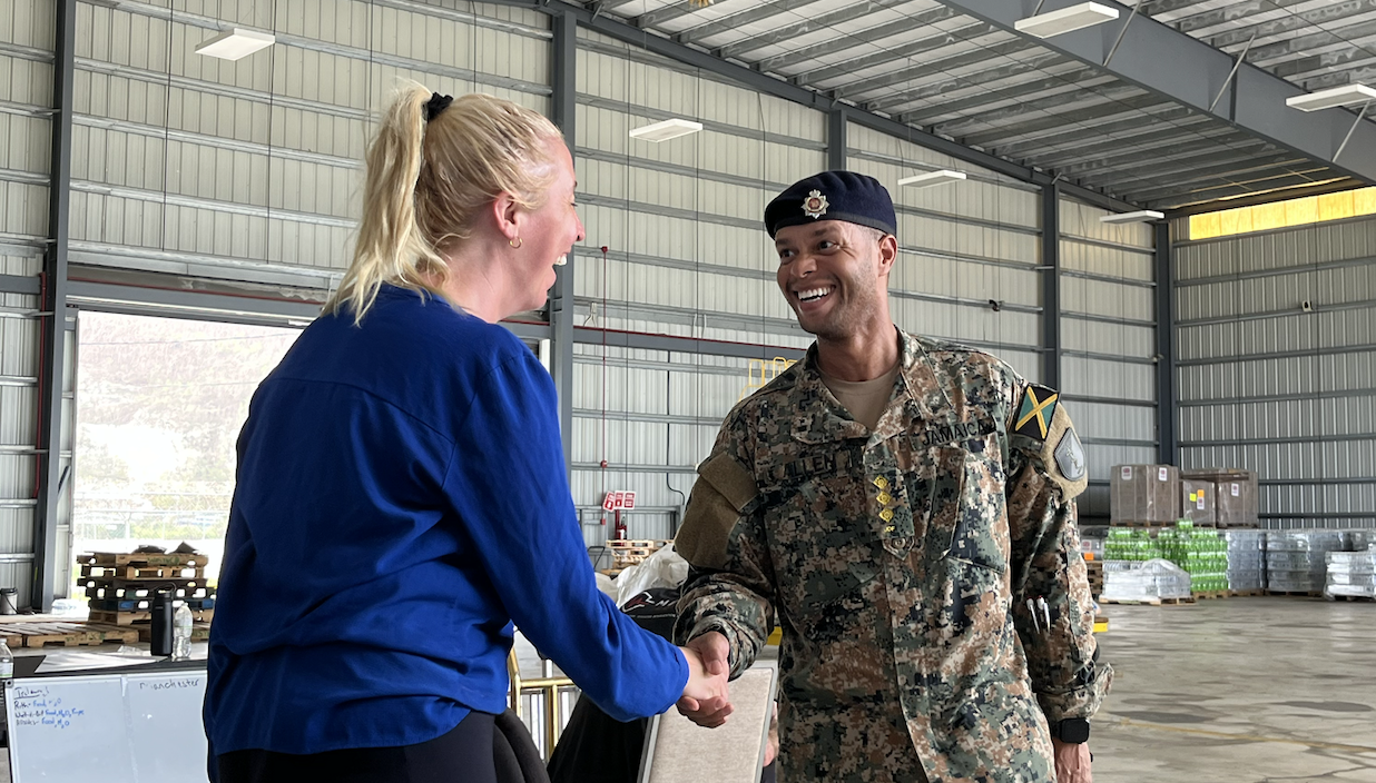 Laurel Hanson shaking hands during a diplomatic meeting